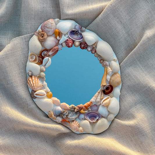 GRACE Seashell Mirror featuring handpicked seashells including scallops, conches, and cockles, set on a premium glass mirror. Measuring 24cm x 18cm, the mirror showcases a unique coastal design perfect for beach-inspired decor